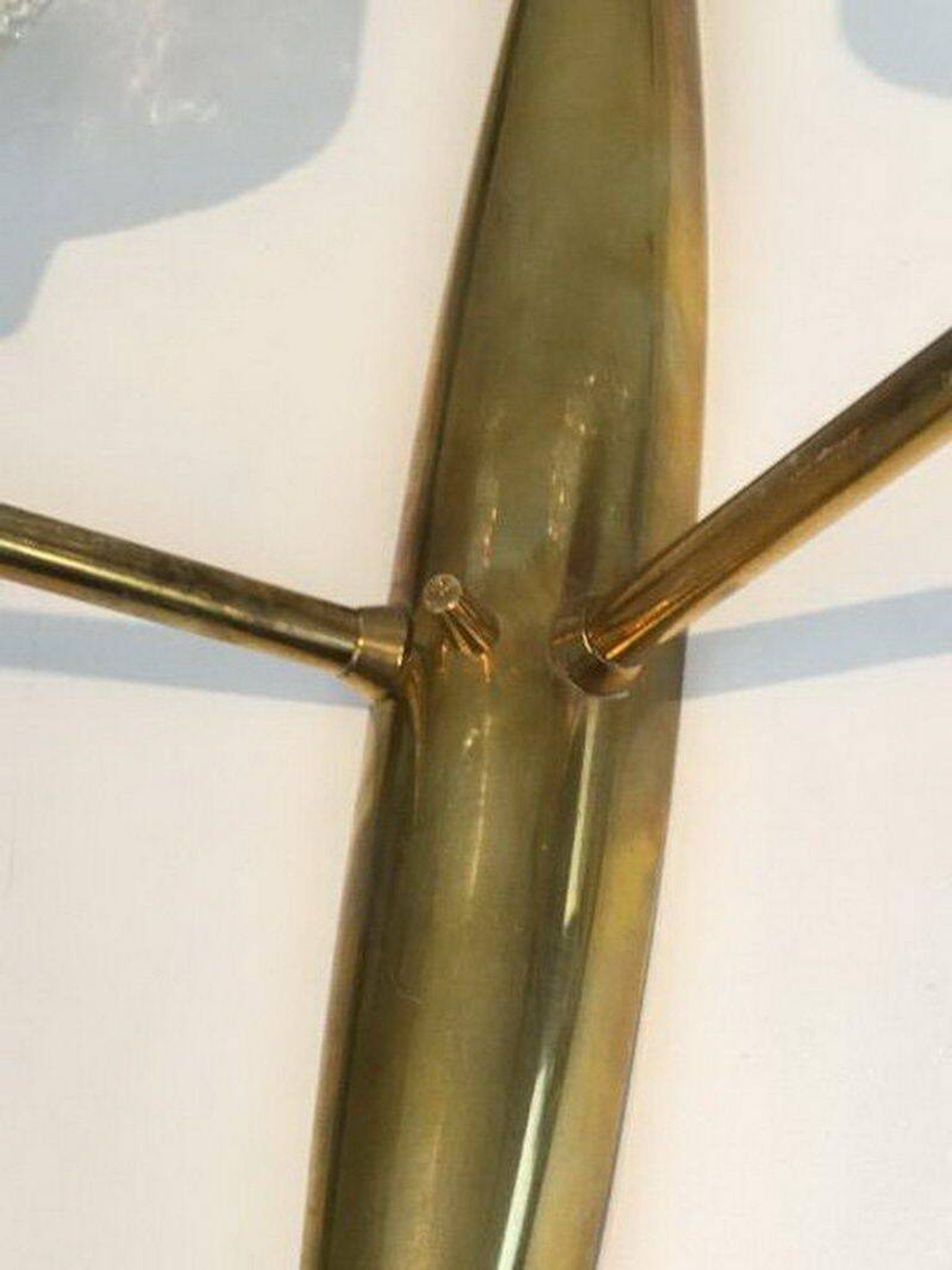 Pair of bronze wall sconces with worked glass reflectors. Stilnovo