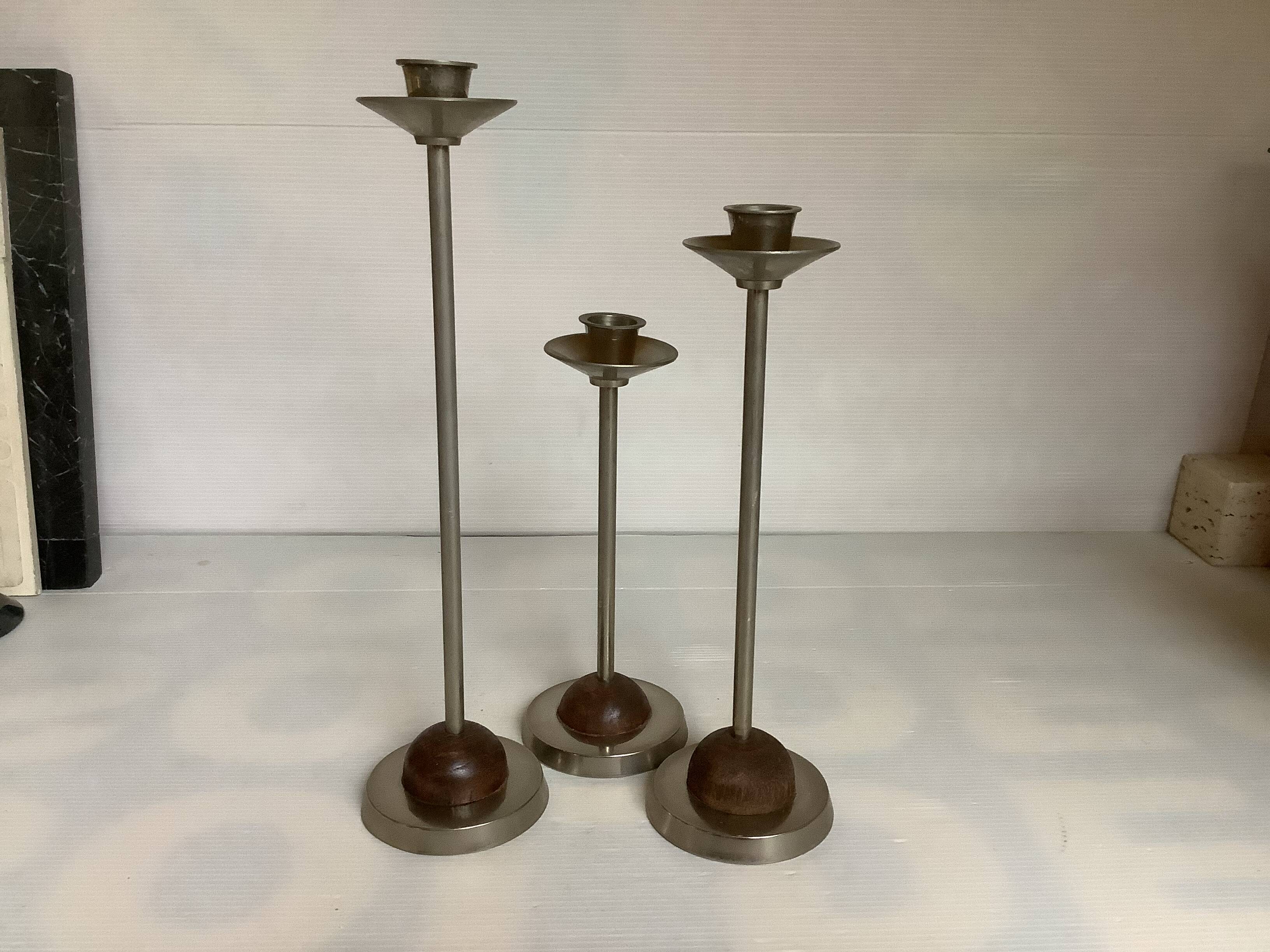 Trio of metal and wood candlesticks
