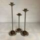 Trio of metal and wood candlesticks