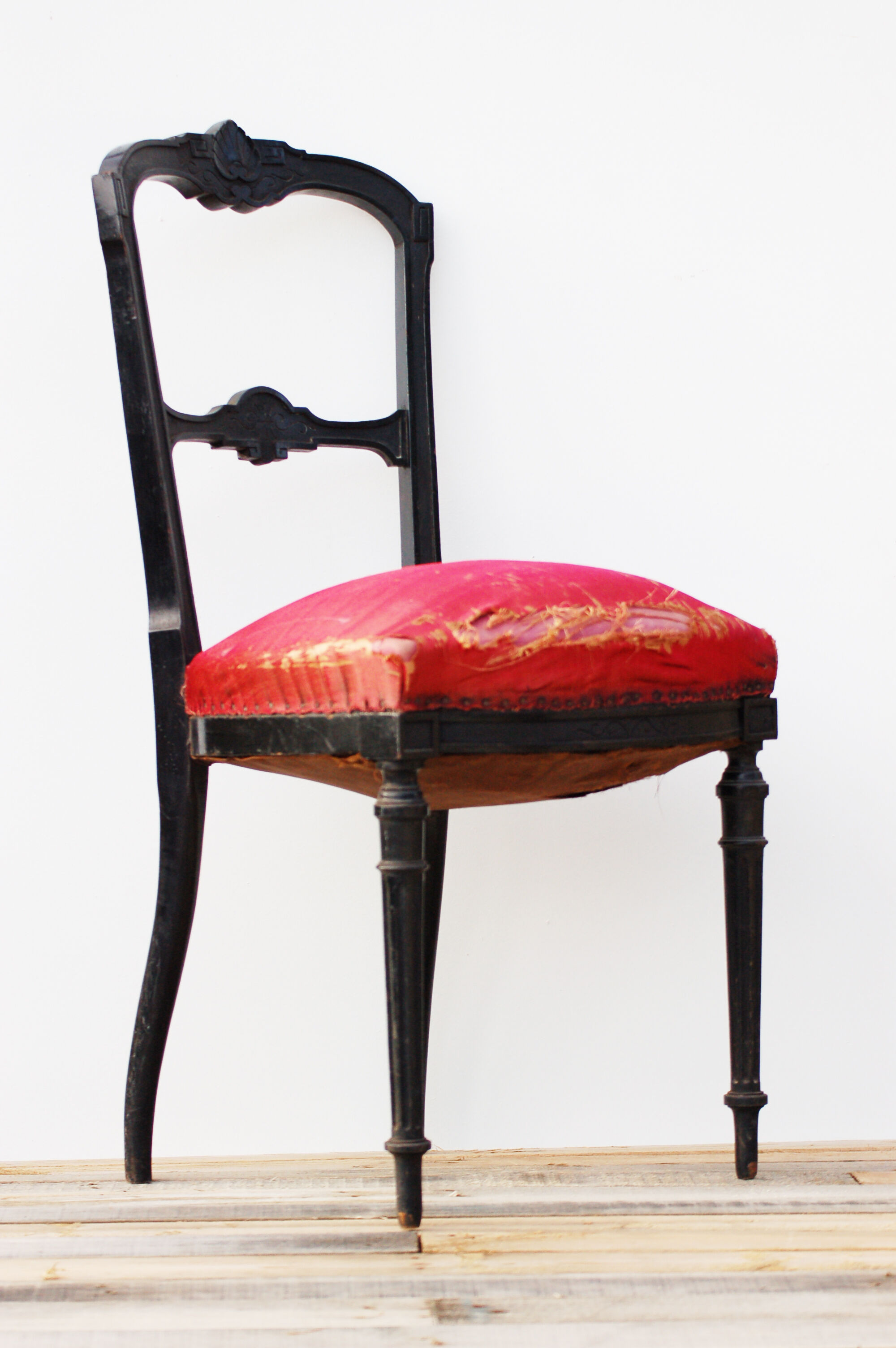 Pair of old black wooden chairs and Red seat.