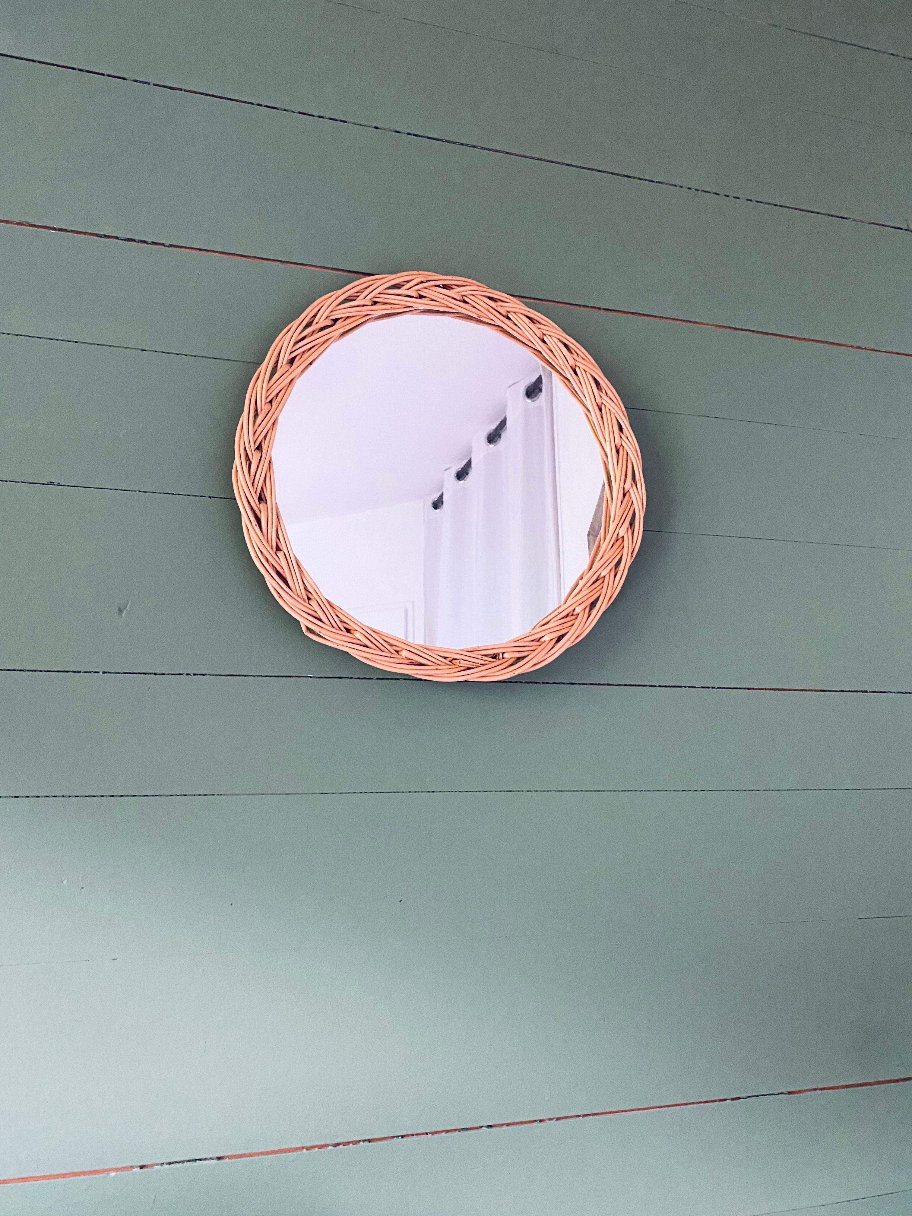 Round mirror in vintage wicker