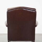 Comfortable and correct dark antique sheepskin English armchair in very good condition