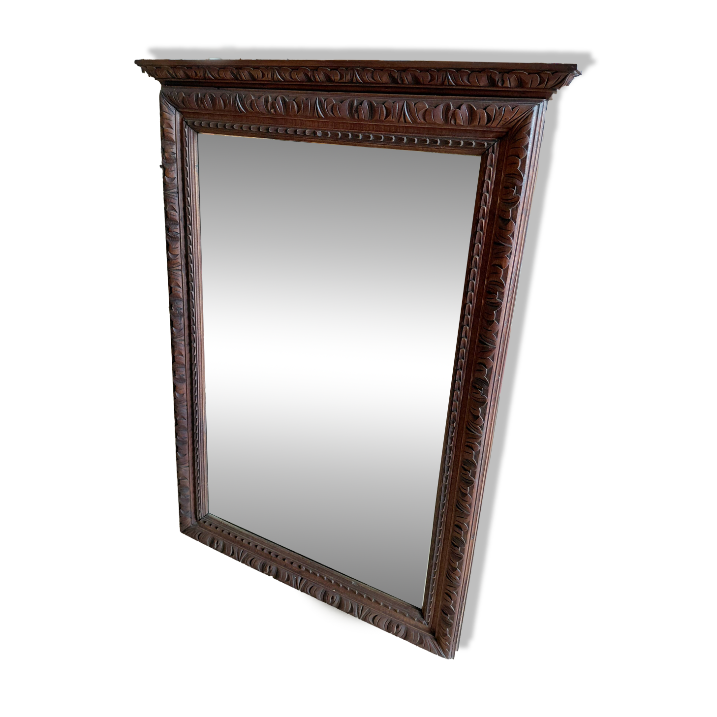 Large bevelled mirror with a carved wooden frame