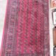 Large red Bokhara-style oriental carpet 300x200 cm with gul patterns.