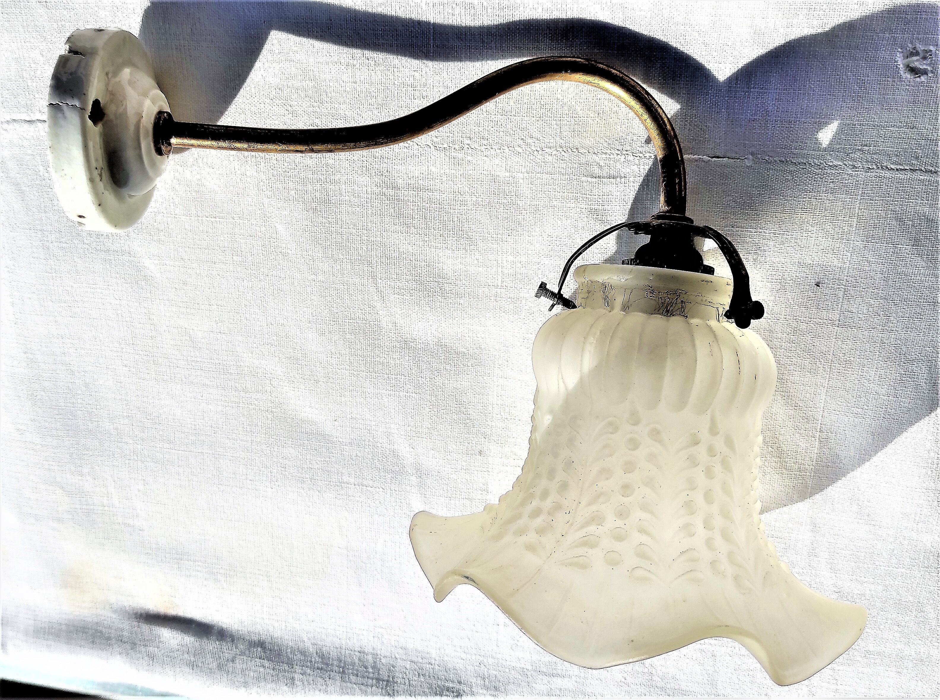 Brass gooseneck wall lamp, with brass socket and porcelain base.