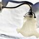 Brass gooseneck wall lamp, with brass socket and porcelain base.