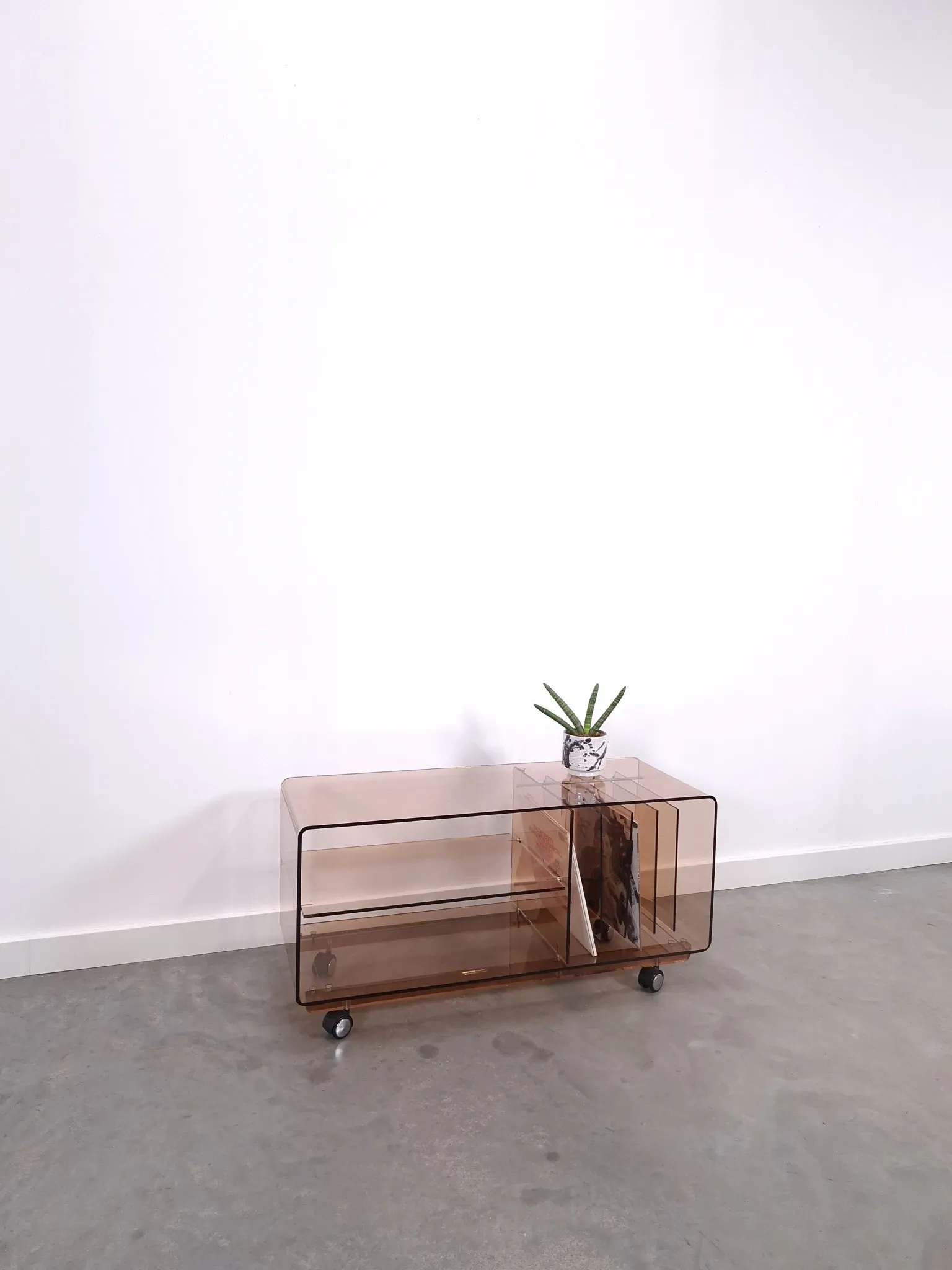 Vintage hifi, LP cabinet, TV unit made of tinted plexiglass on wheels, records.