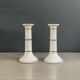 Pair of porcelain candlesticks with a gold pattern.