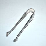 Rocaille sugar tongs in silver metal with lion claw medallion