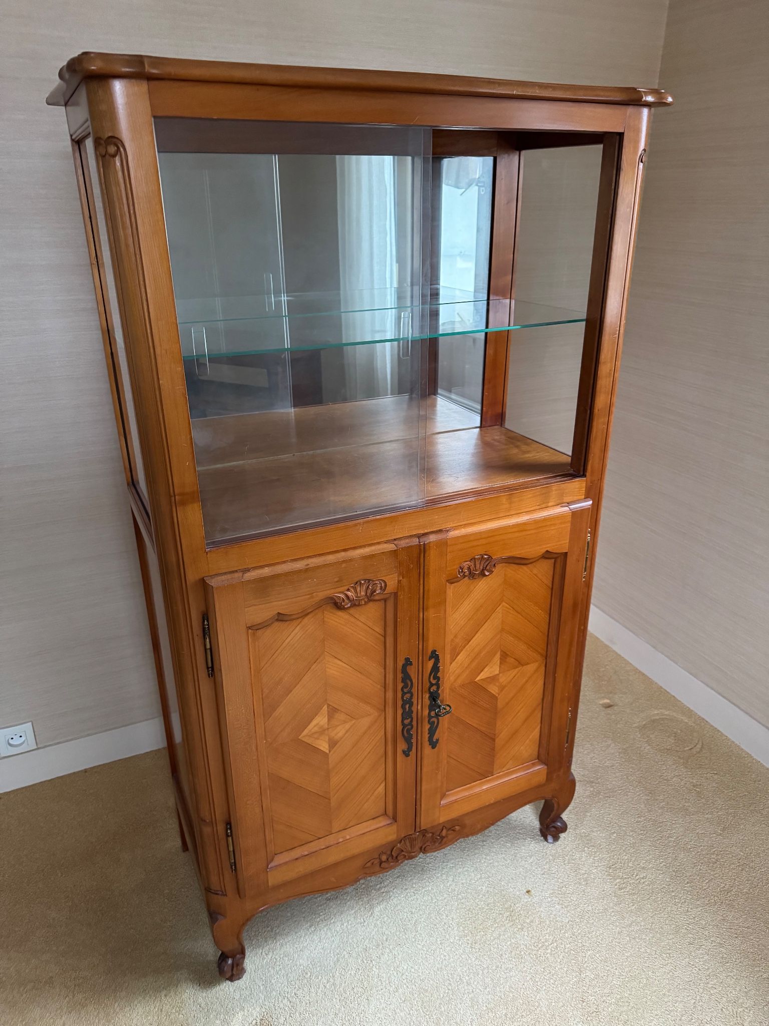 Louis XV style display cabinet, glass doors and chevron panels.
