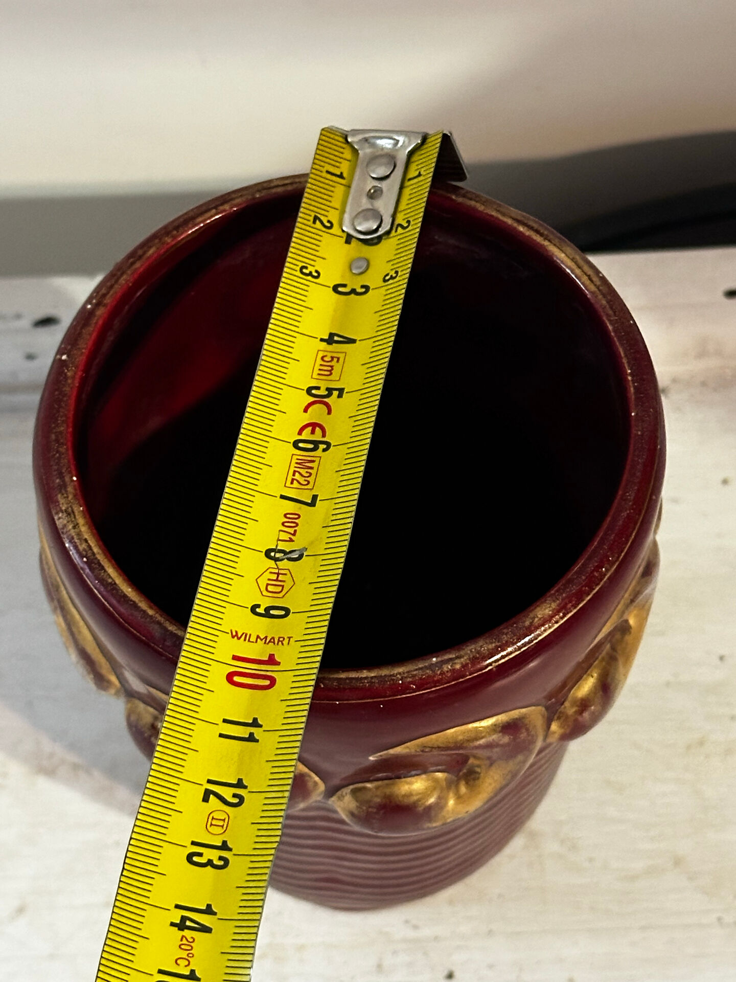Mid-century relief vase in ruby red enhanced with gilding.