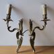 Pair of symmetrical gold wall sconces in baroque style made of bronze.