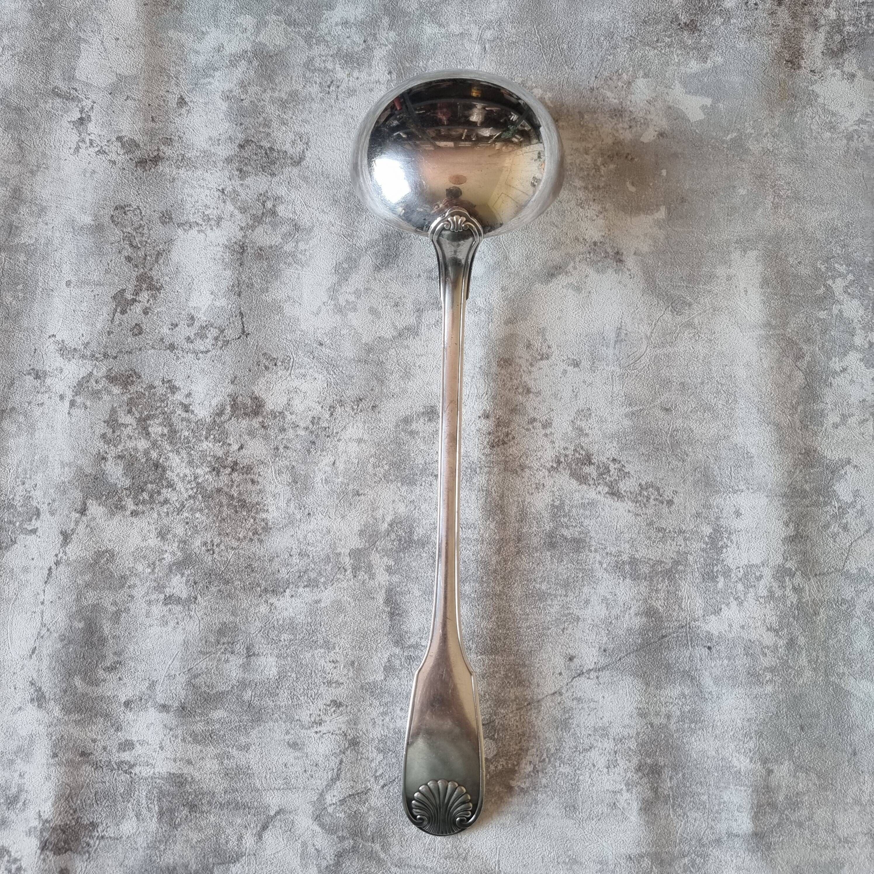 The Christofle silver-plated “Vendôme” cream ladle features a design