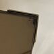 Set of three nesting side tables in brass and smoked mirror.