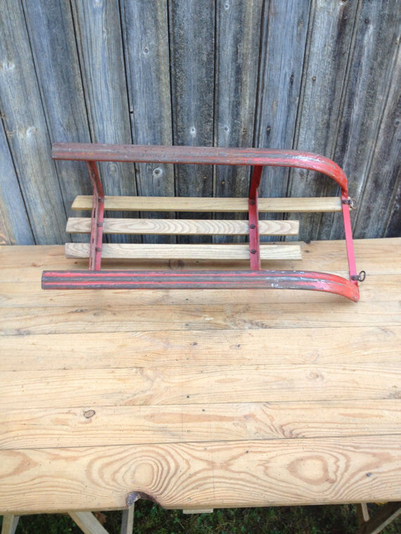 Red sled in metal and wood in the 1960s