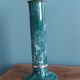 Column candle holder in ceramic with green and gold marble effect.