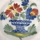 Assiette ancienne en faïence d’auvillar à décor de corbeille de fleurs polychrome