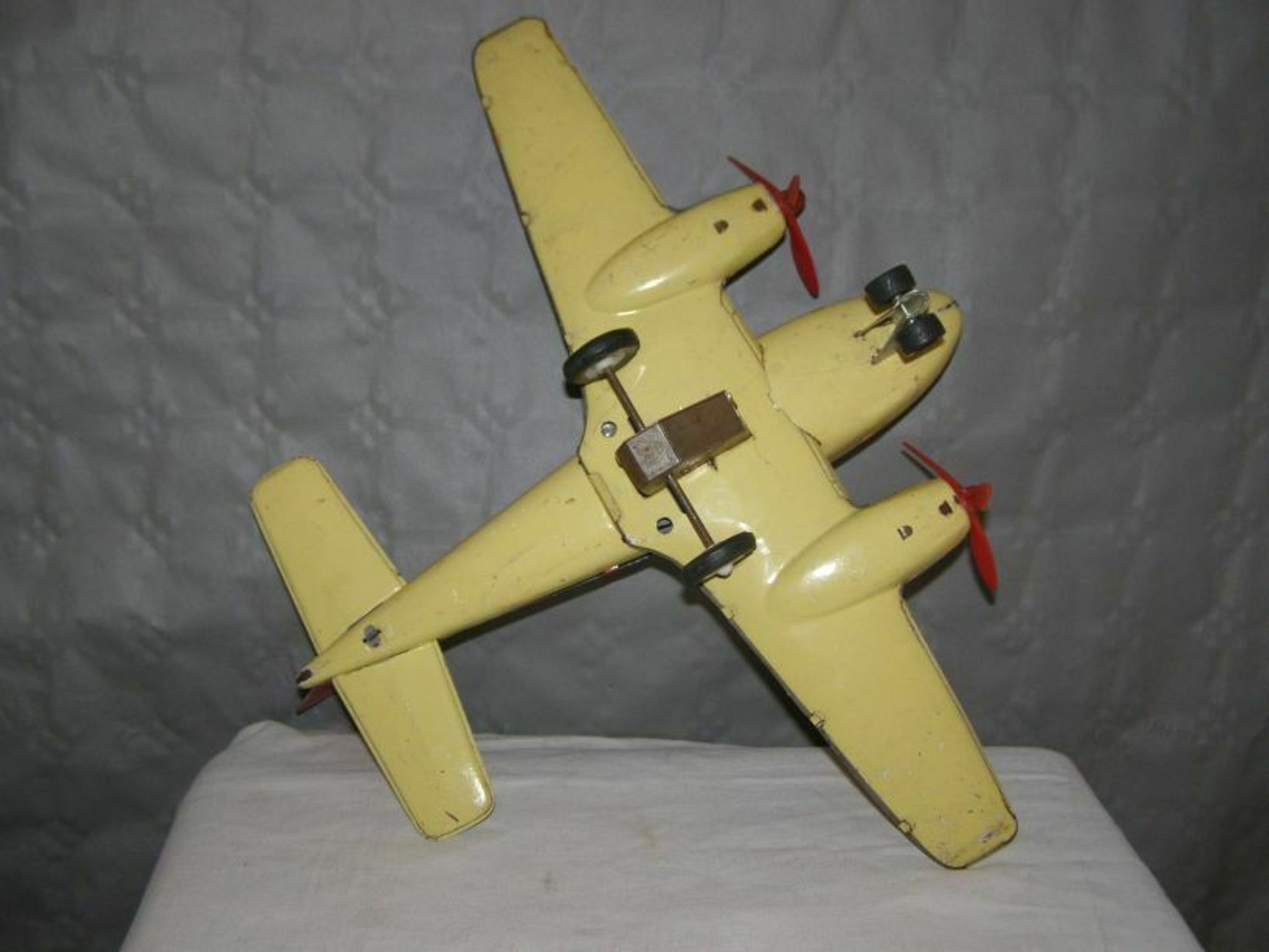 Old metal Joustra toy; propeller aircraft with its pilot friction mechanism