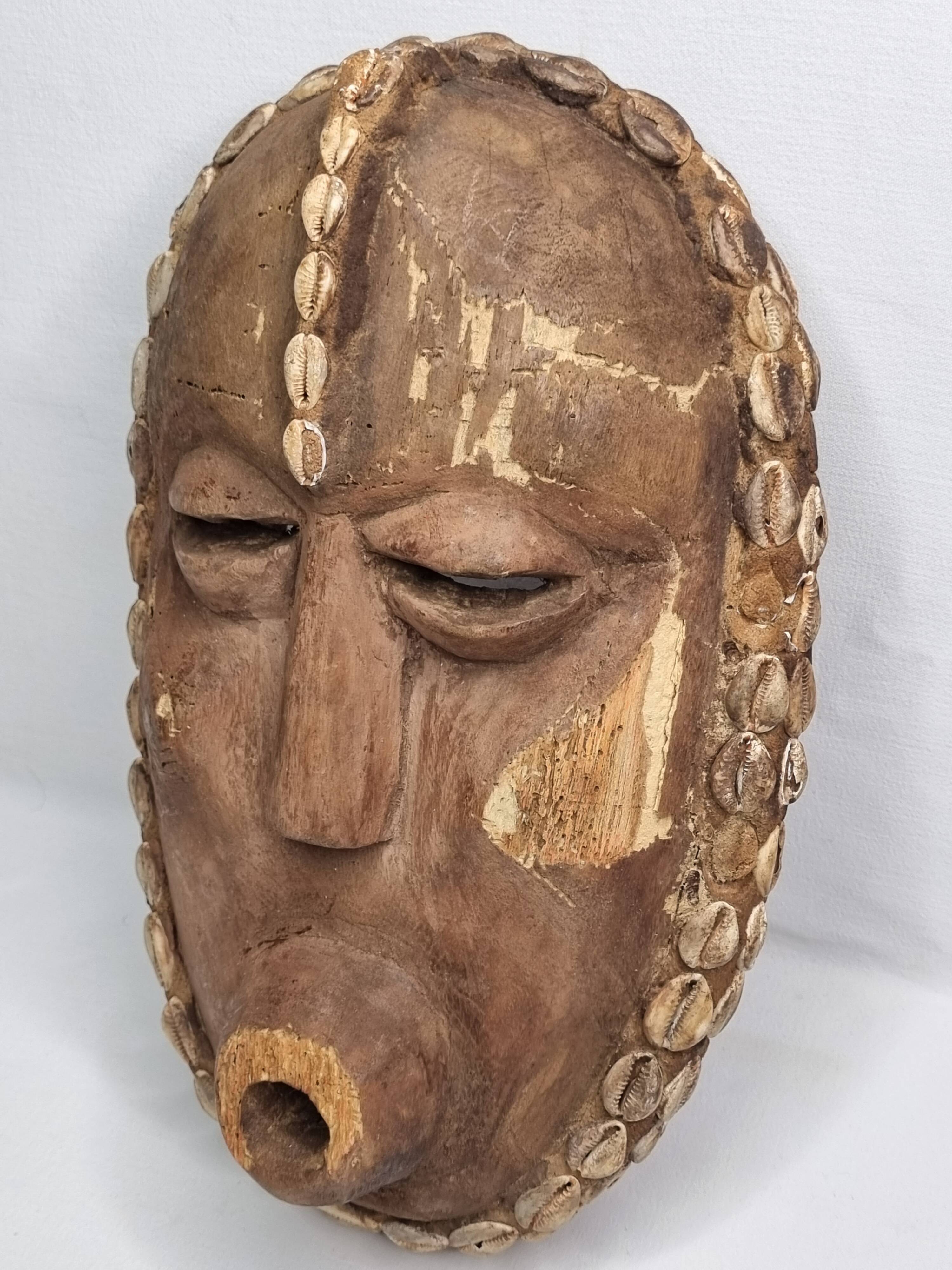 Decorative African mask in carved wood and cowrie shells, Baoulé style, 34 cm