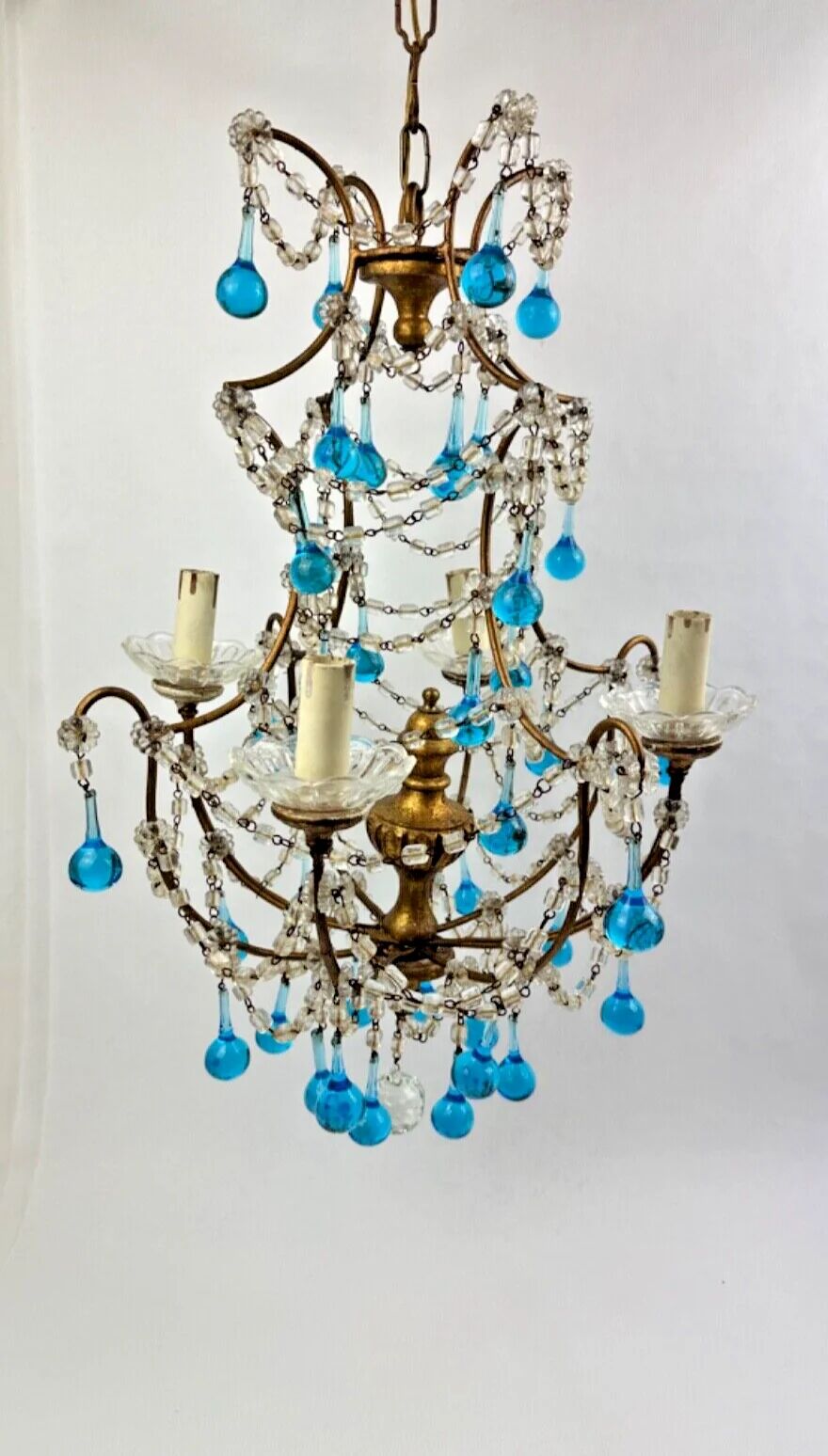 Italian chandelier with blue beads and gilded wood.