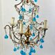 Italian chandelier with blue beads and gilded wood.