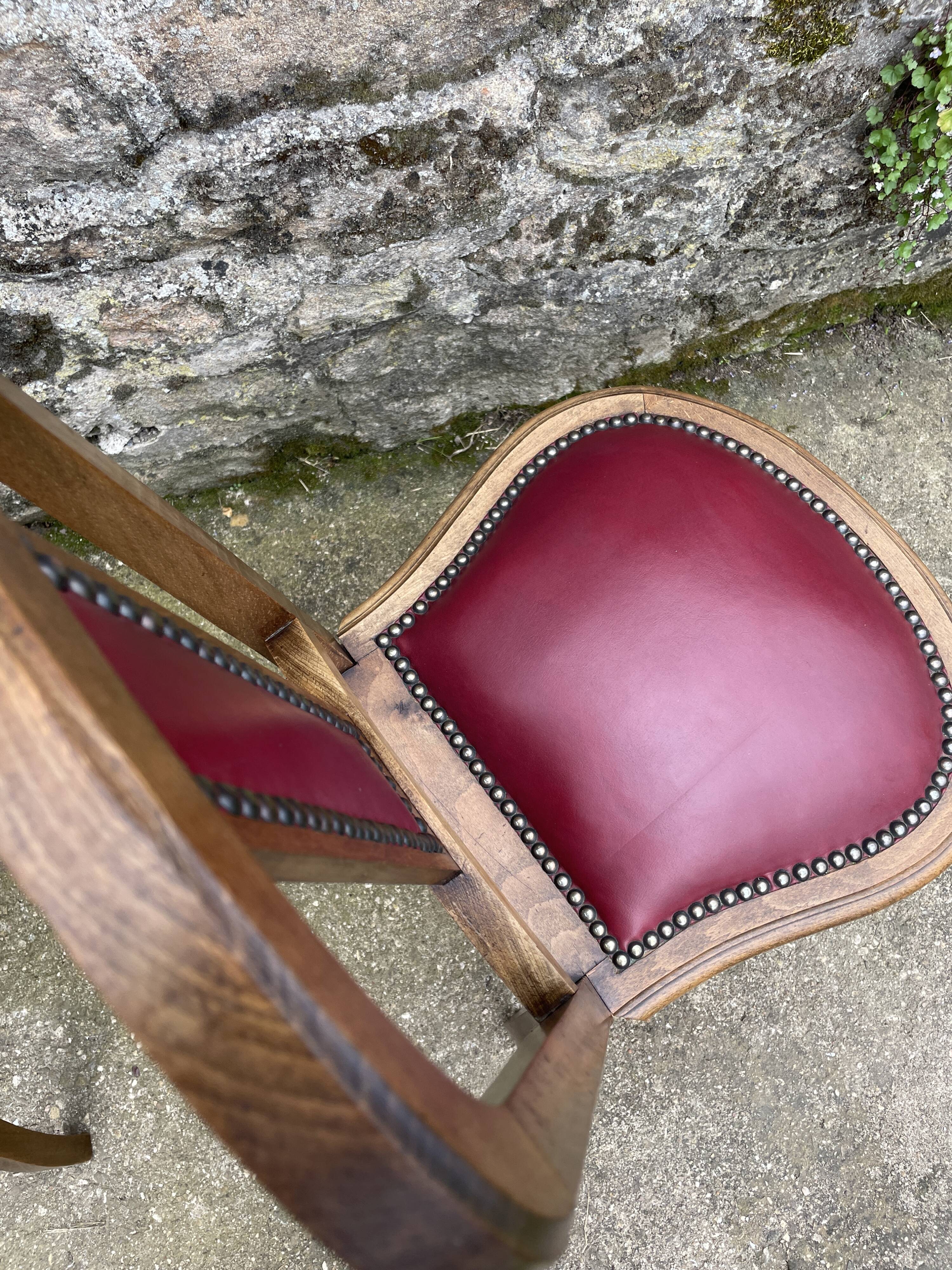 Pair of studded burgundy leather Art Deco chairs