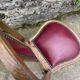 Pair of studded burgundy leather Art Deco chairs
