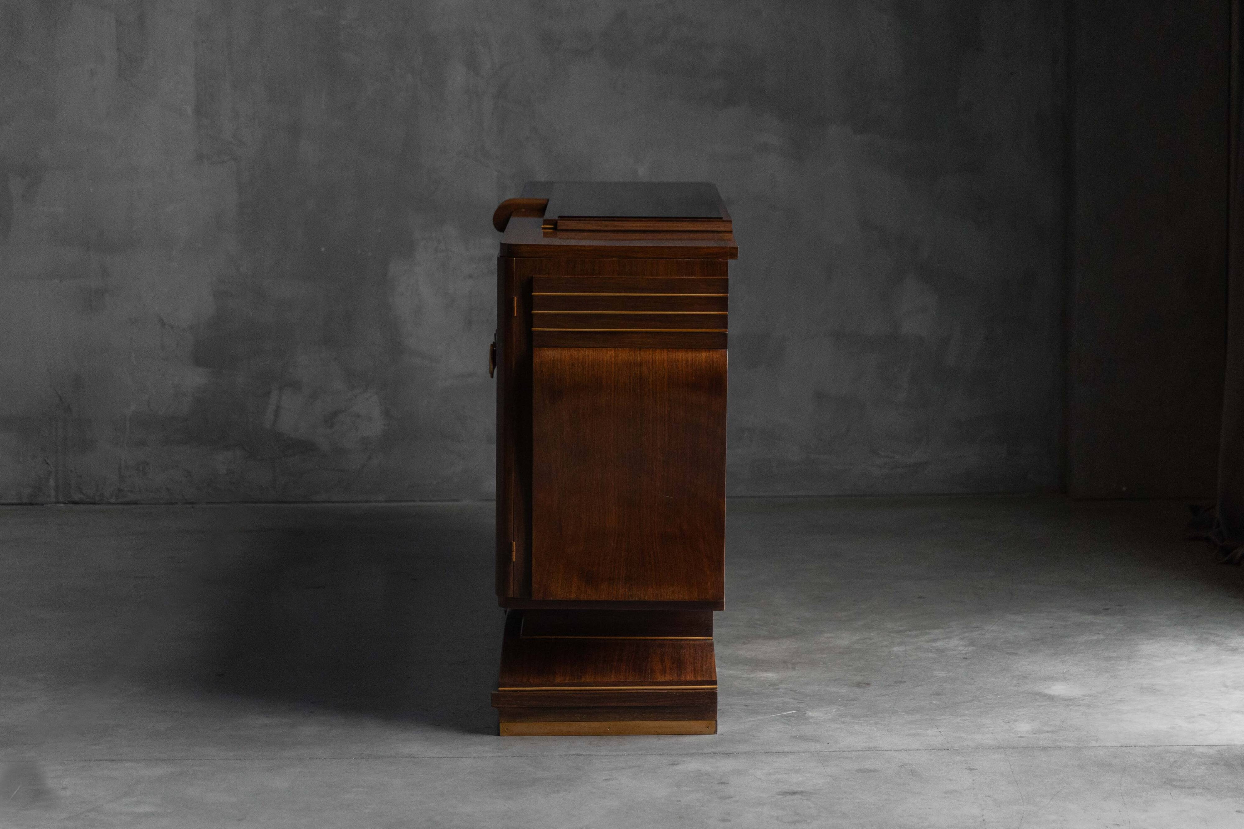 Art Deco walnut sideboard with brass details and sculptural base, France, 1930s