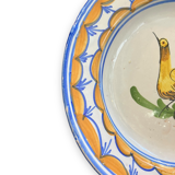 Earthenware plate representing a bird signed Lario