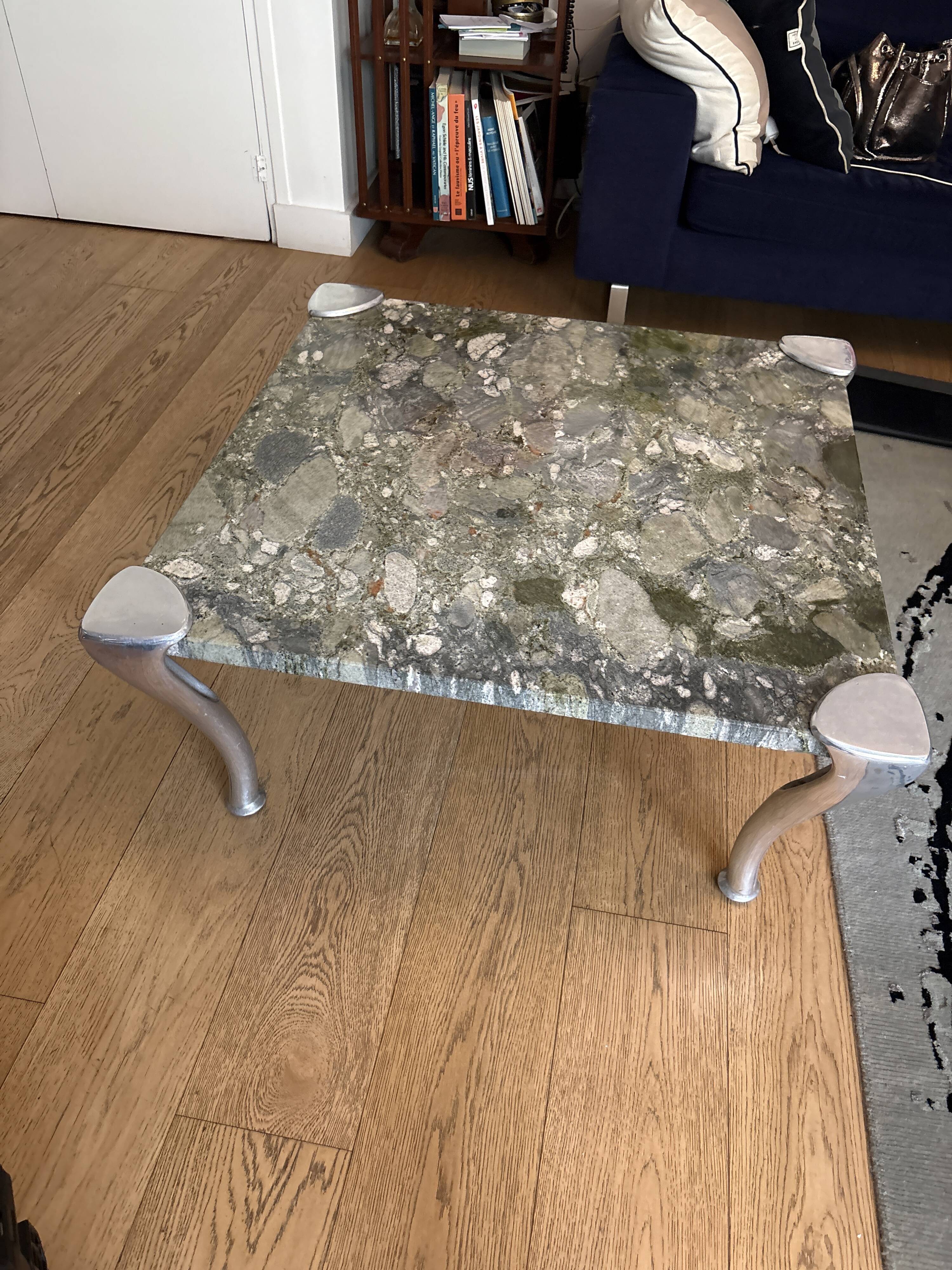 Contemporary coffee table with a marble top and steel base.