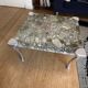Contemporary coffee table with a marble top and steel base.