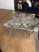 Contemporary coffee table with a marble top and steel base.