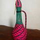 Old glass bottle and scoubidou