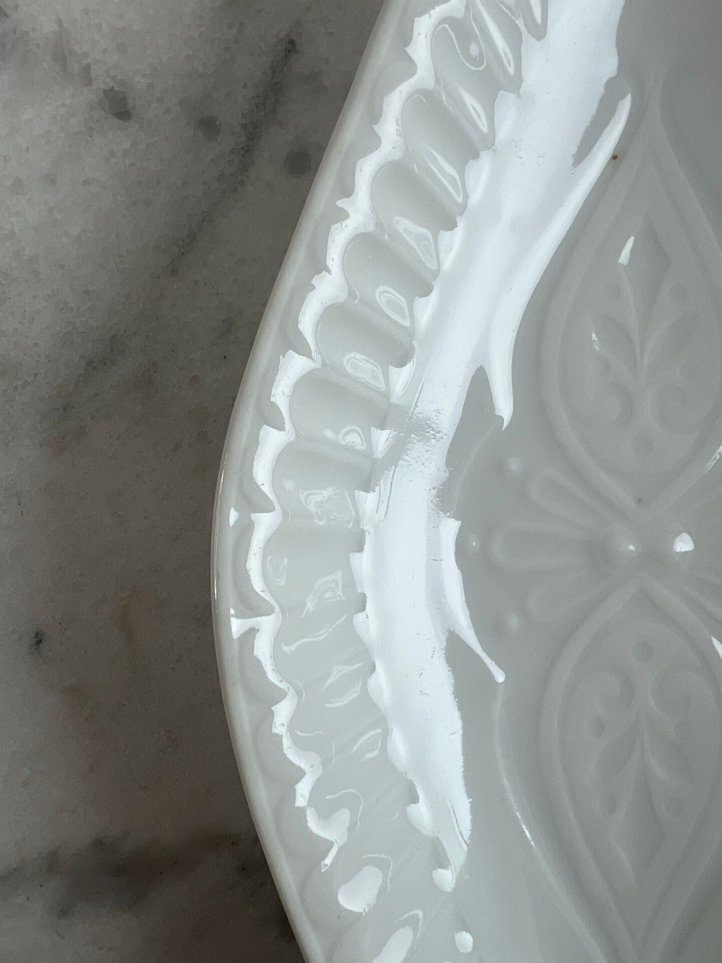 Oval white porcelain ramekin — raised floral pattern