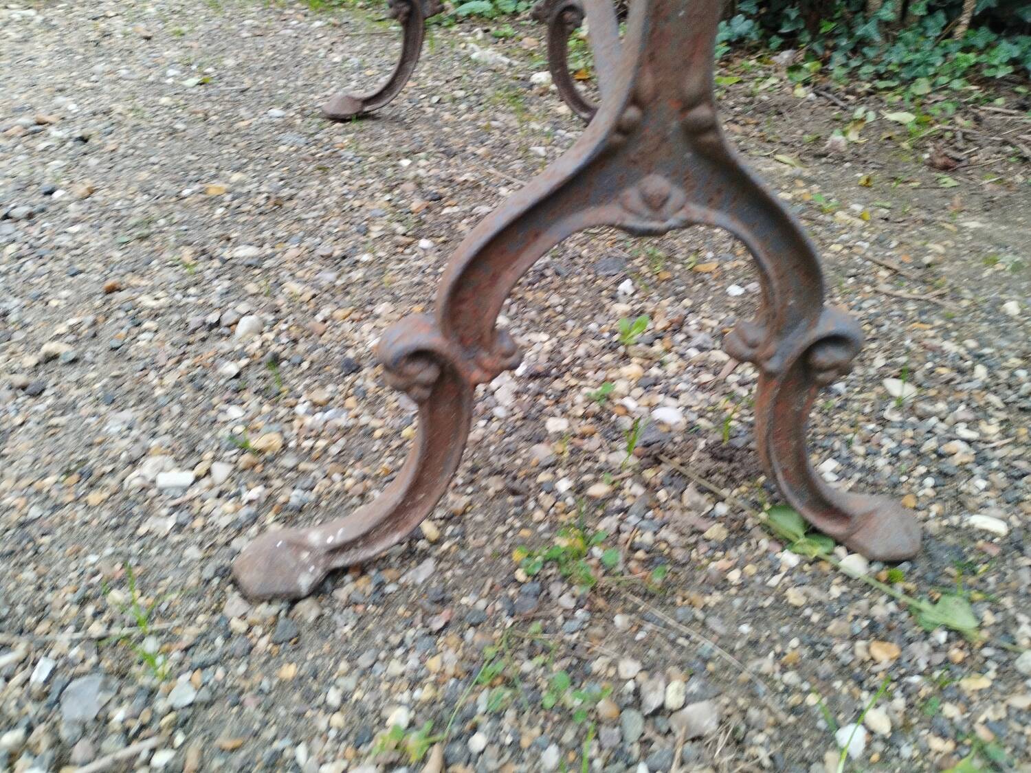 Antique bistro table with iron legs and wooden top