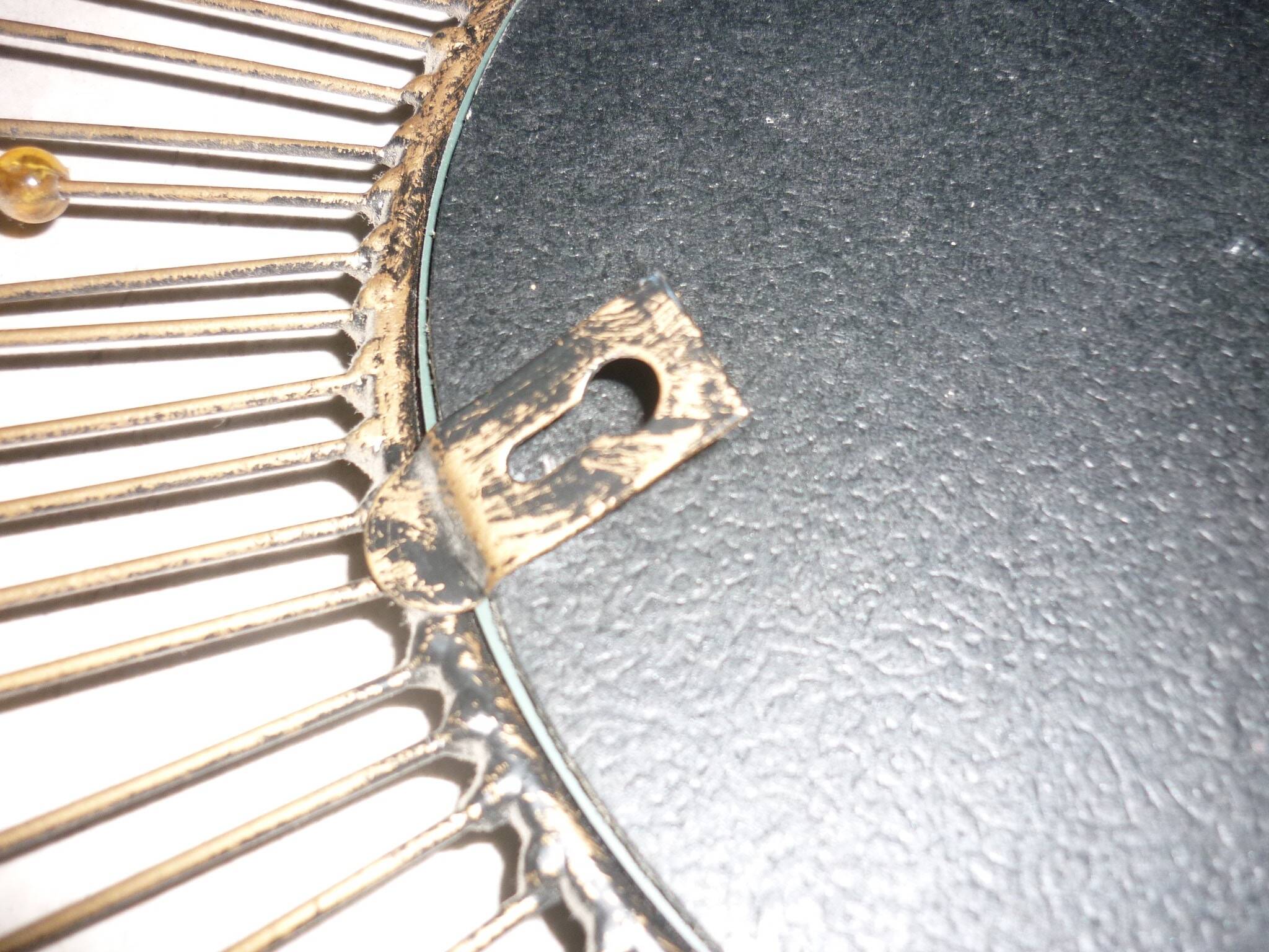 Round sun mirror with pearl rays and leaves