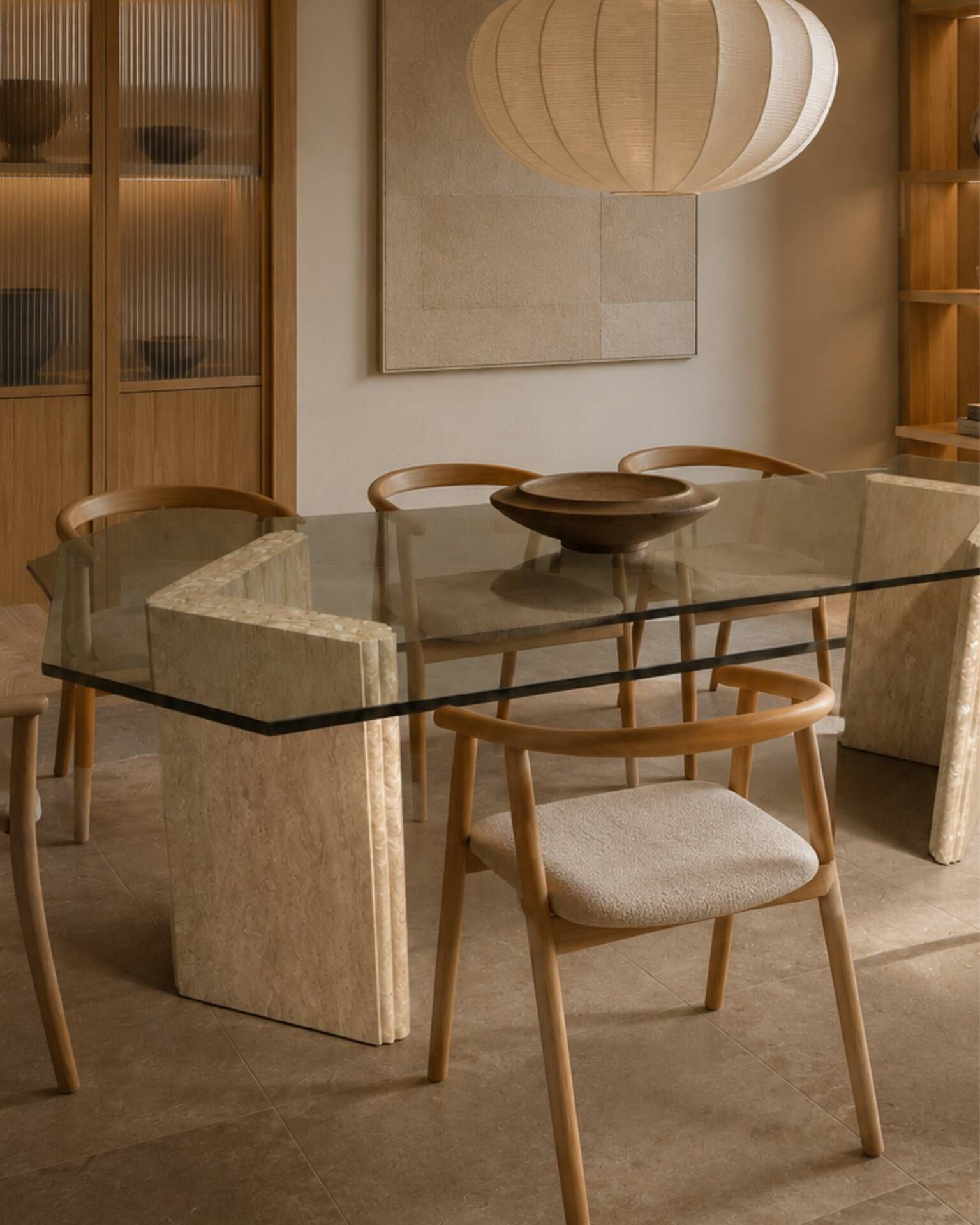 Dining table in travertine and smoked glass.