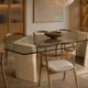 Dining table in travertine and smoked glass.