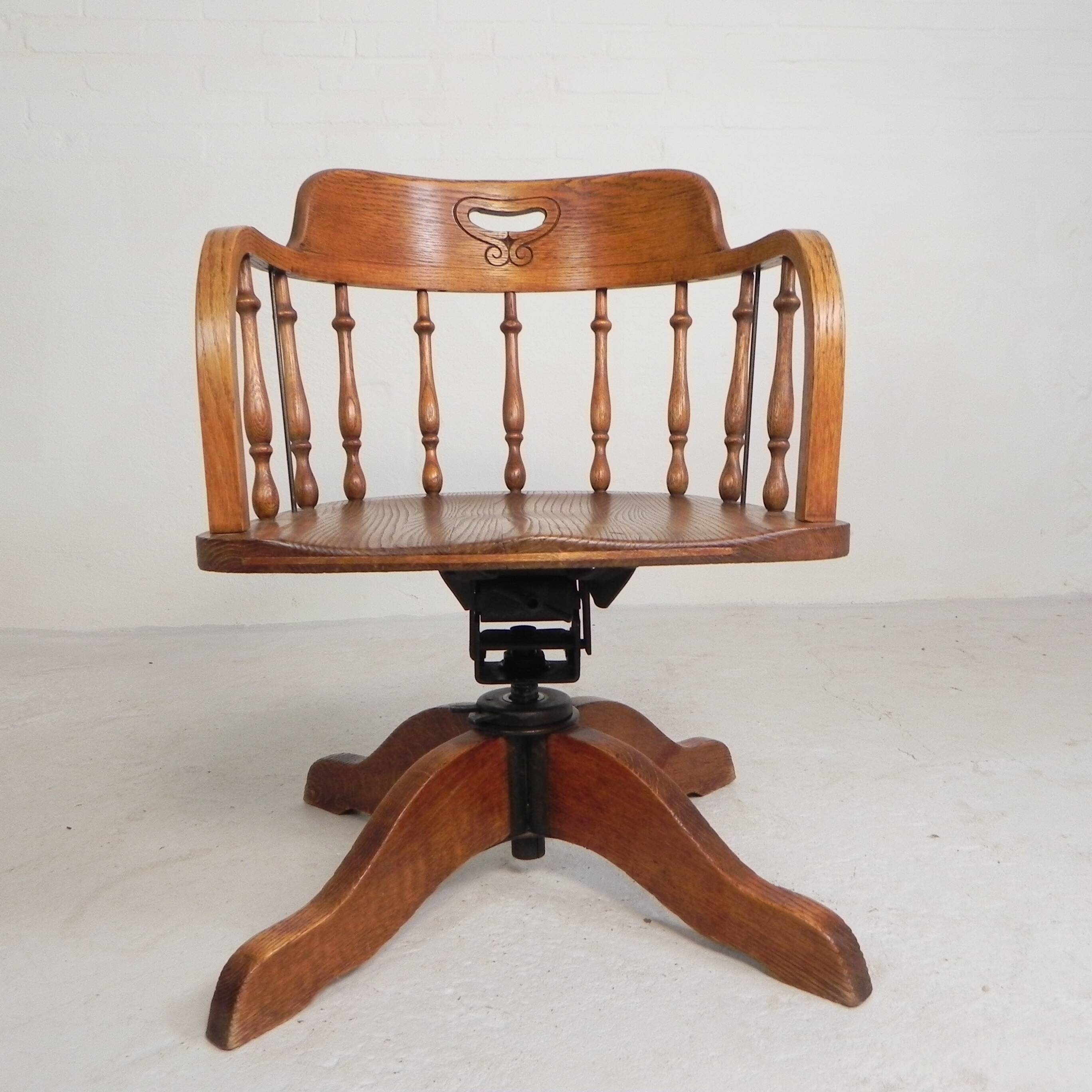 Oak office chair with a spring system and height adjustable, 1930s.