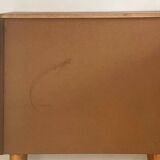 Vintage 1960s chest of drawers with covered handles.