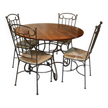Table and four wrought iron and wood chairs.