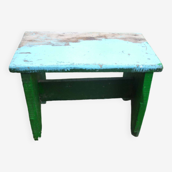 Low bench in green and blue brutalist wood