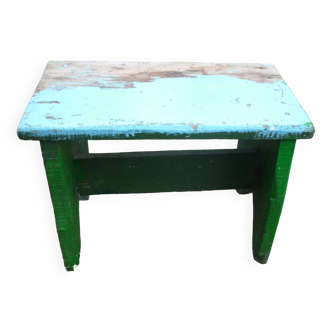 Low bench in green and blue brutalist wood