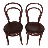 pair of round bistro chairs with a pattern on the seat, vintage