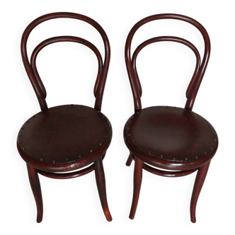 pair of round bistro chairs with a pattern on the seat, vintage