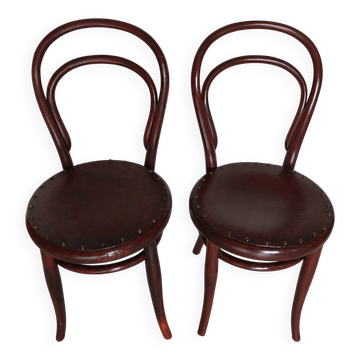 pair of round bistro chairs with a pattern on the seat, vintage