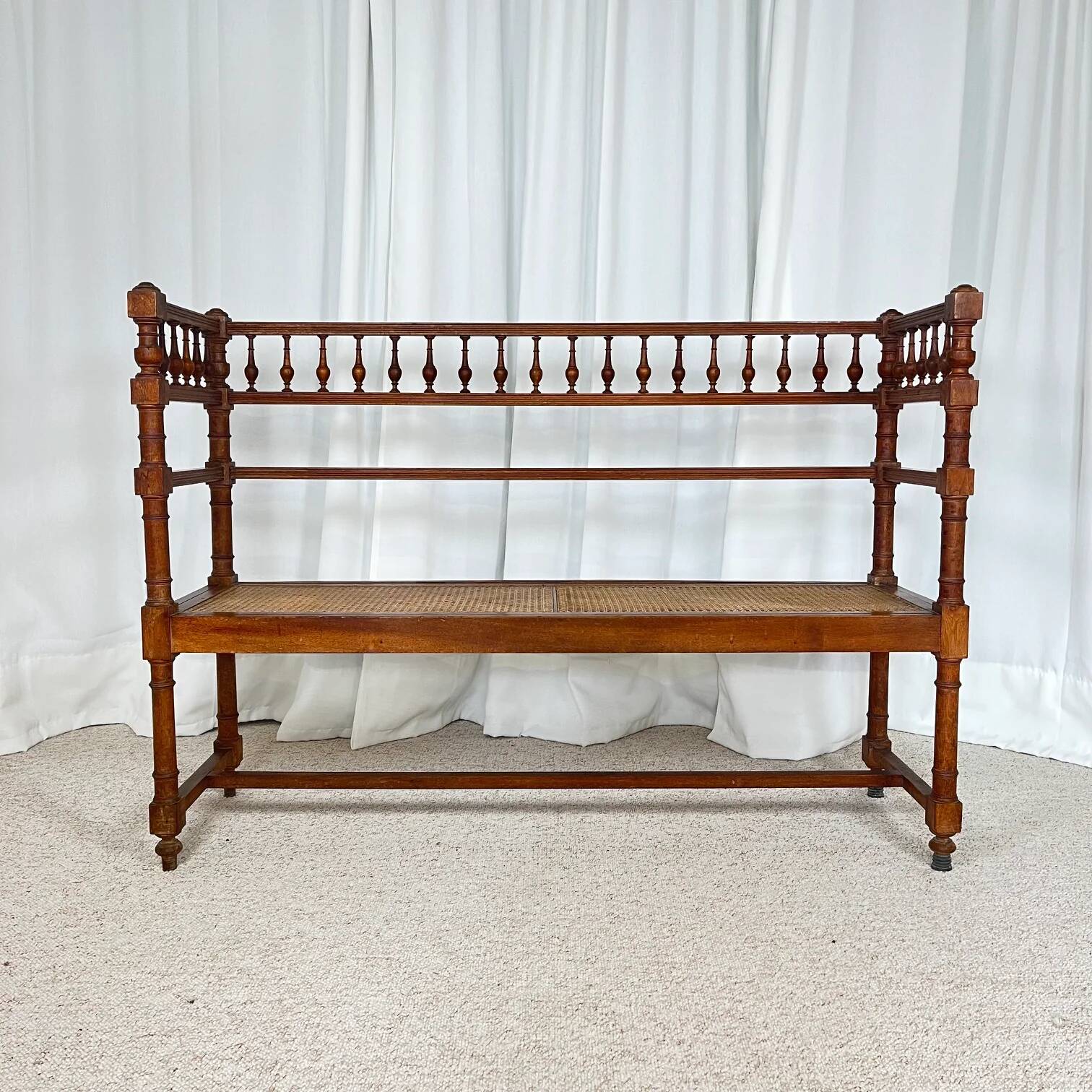 Antique banquette in Louis XIII style, turned wood with caning, late 19th to early 20th century.