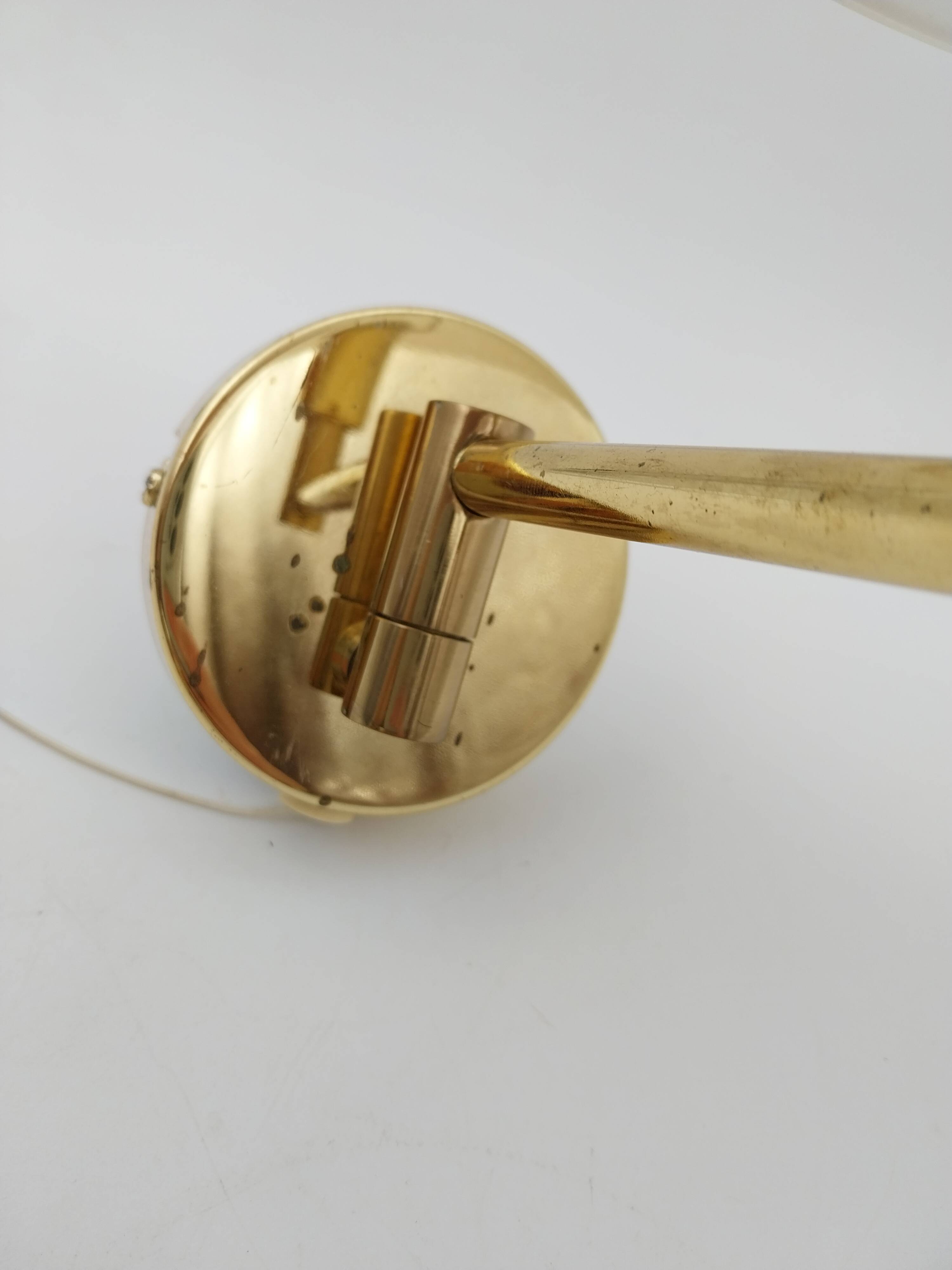 Pair of articulated arm wall lights in brass with opaline globe