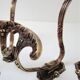 Four patères bronze patinated leafy décor early 20th century