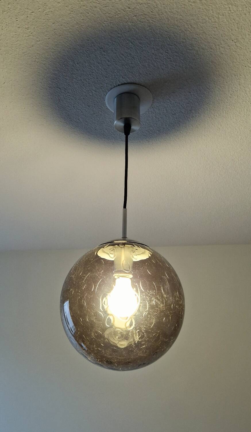 Smoked glass ball pendant light by Raak 1970